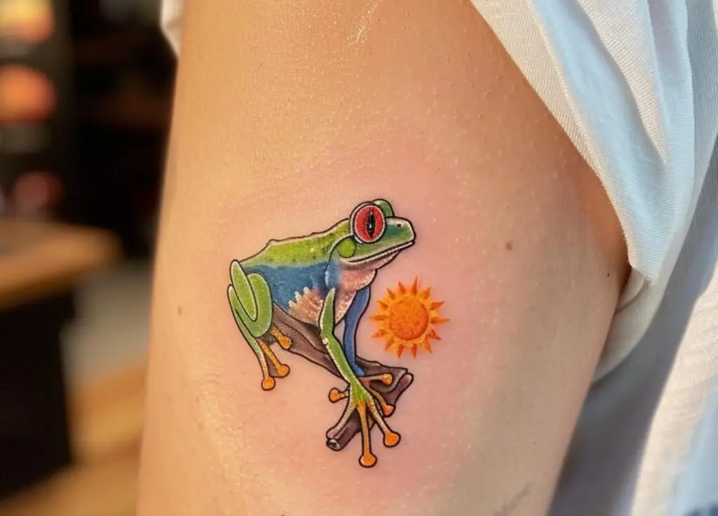 Frog with tribal sun tattoo